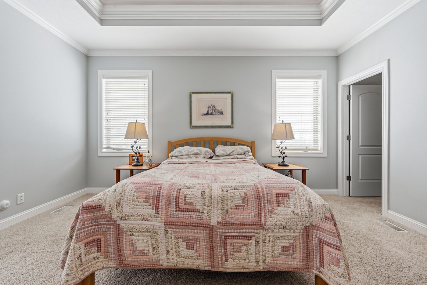 Primary bedroom with tray ceiling and temple views