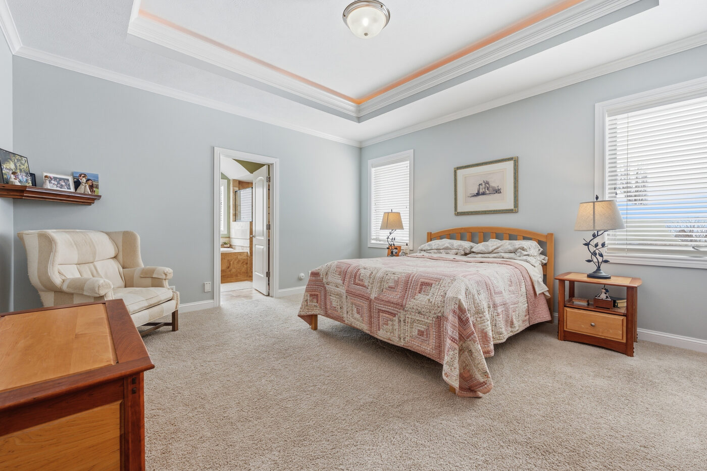 Primary bedroom — wide angle with en-suite access